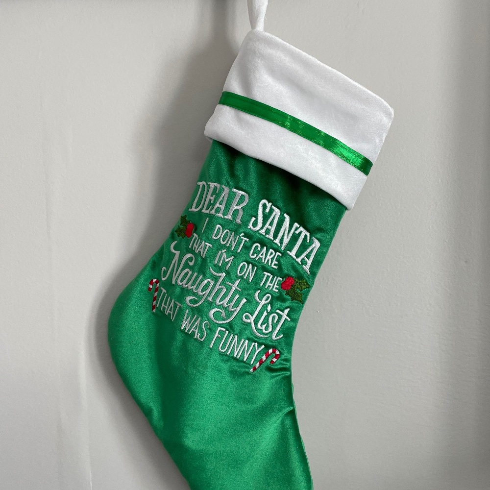 Handcrafted naughty list Christmas stocking in green.
